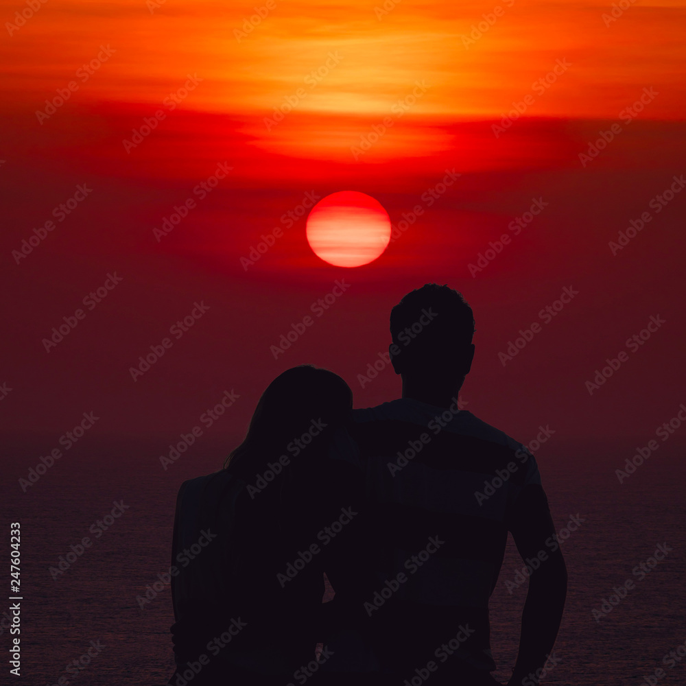 Silhouette of a couple watching the tropical sunset.