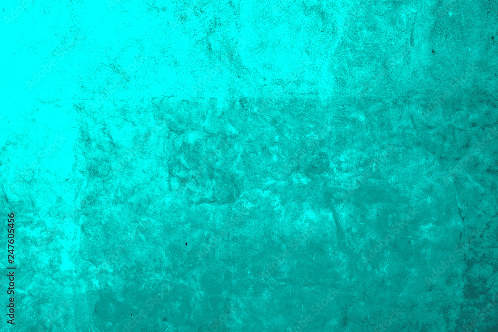 Old concrete wall sloppy painted turquoise