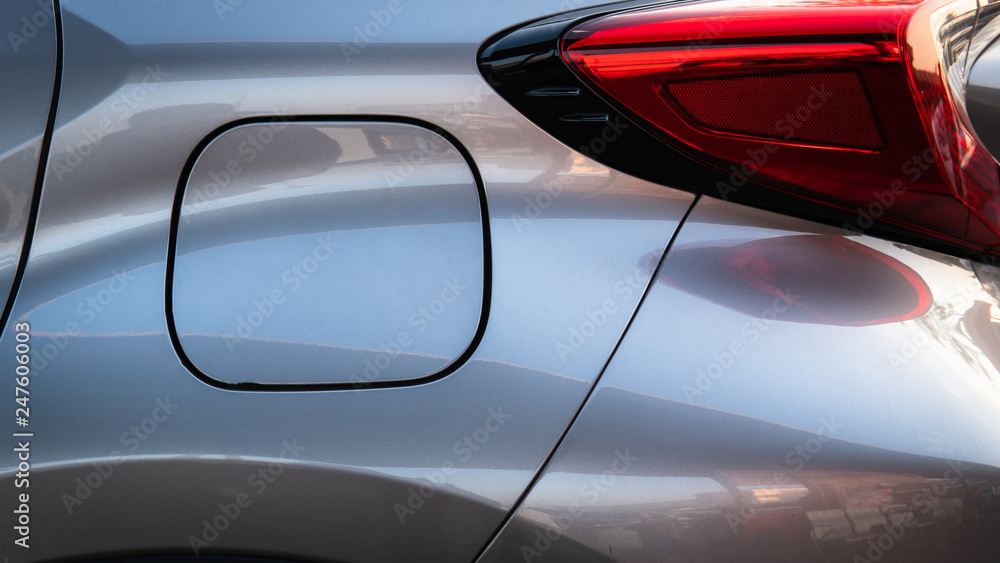 Close up of car petral lid with back light on the grey metalic shiny car. Close up of car petral lid with back light on the grey metalic shiny car.