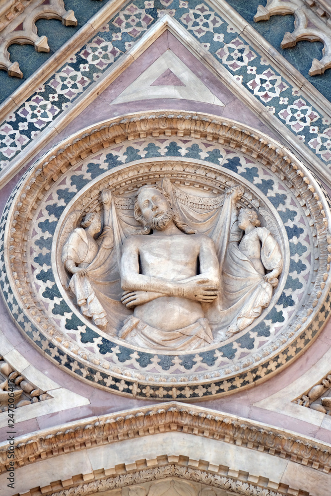 Wrapping Christ in his shroud, Portal on the side-wall of Cattedrale di Santa Maria del Fiore (Cathedral of Saint Mary of the Flower), Florence, Italy 