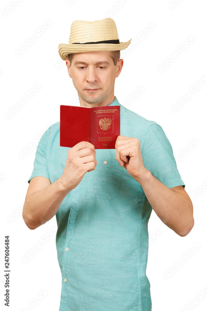 The man looks in the opened international passport. A look in a fullface The man looks in the opened international passport. A look in a fullface
