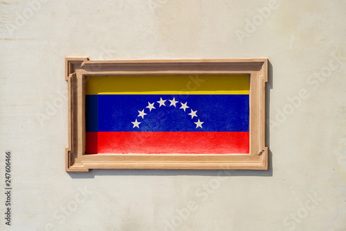 Stone frame with the image of the flag of Venezuela on an old building photo