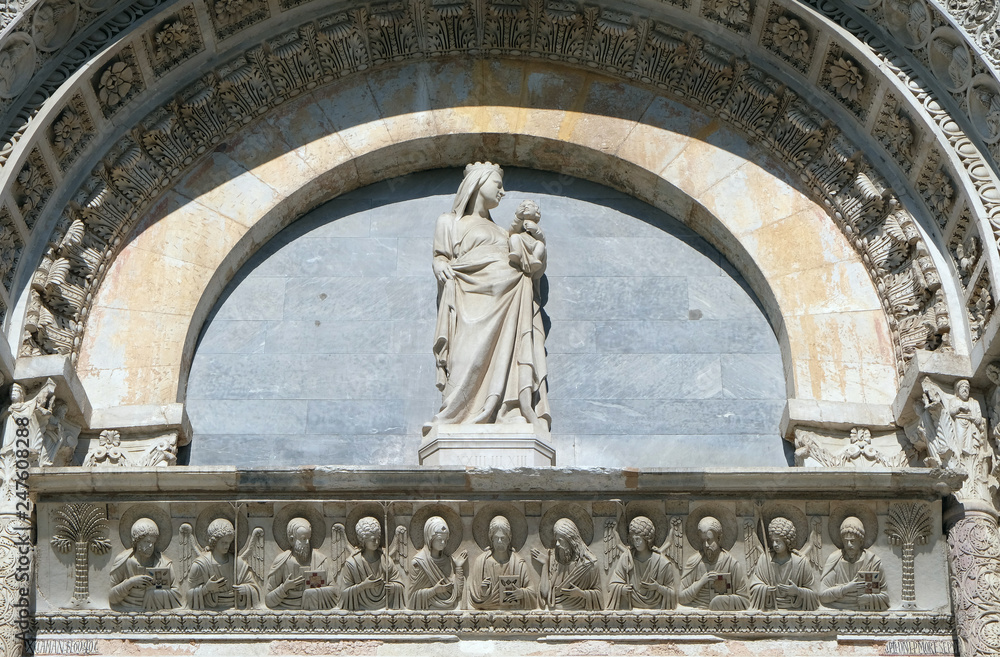 Virgin Mary with baby Jesus above Entrance Door of Cathedral Church Baptistery in Pisa, Italy Virgin Mary with baby Jesus above Entrance Door of Cathedral Church Baptistery in Pisa, Italy