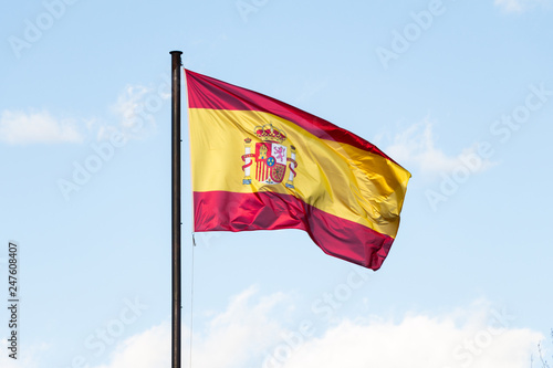 Spanish flag waving in the wind on blue sky
