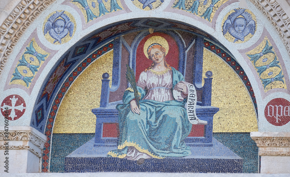 A colourful mosaic by Giuseppe Modena da Lucca, of the Saint Reparata, lunette above left door of Cathedral in Pisa, Italy. Unesco World Heritage Site
