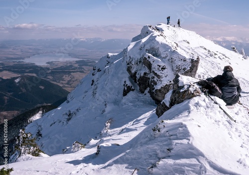 Panorama with big mountains and resting tourists, winter time