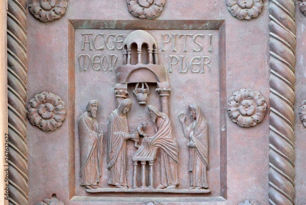 Presentation of Jesus in the Temple on the San Ranieri gate of the Cathedral St. Mary of the Assumption in Pisa, Italy 