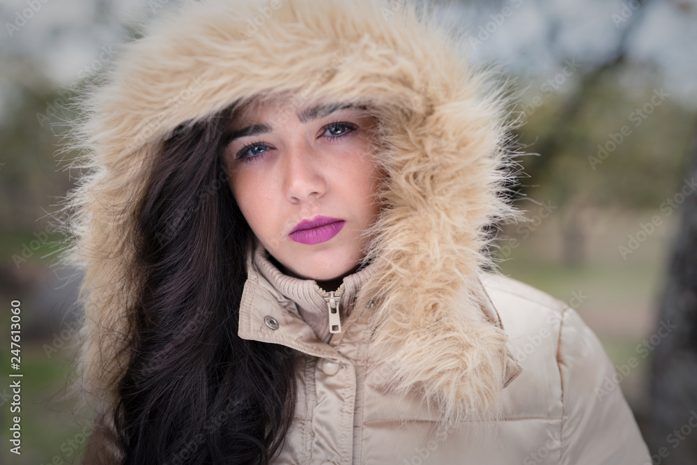 Portrait of young woman with hood. Portrait of young woman with hood.