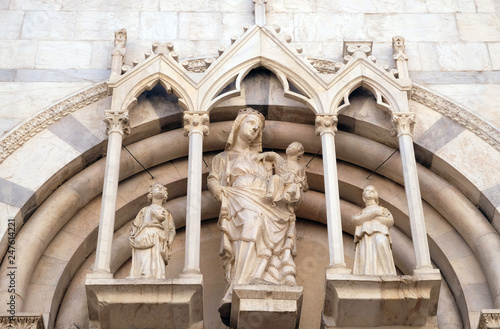 Virgin Mary with baby Jesus and Saints, portal of Saint Michele in Borgo church in Pisa, Italy photo