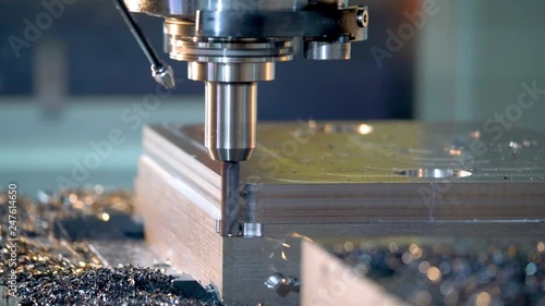 CNC milling machine cutting steel in a machine shop.