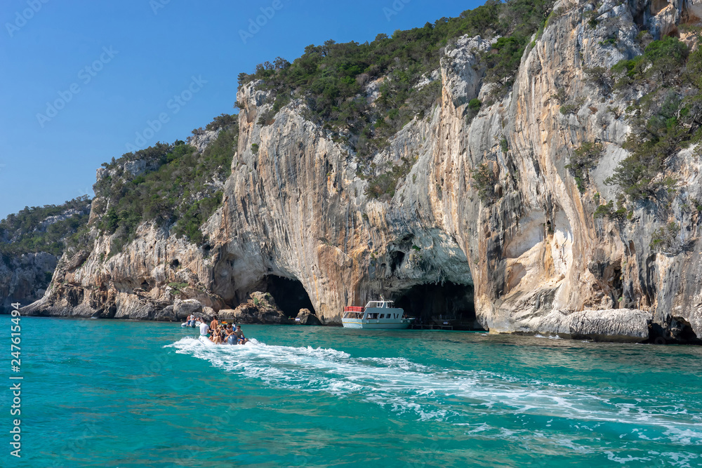 Sardinia-August 2018: Boats with tourists explore grottos of east shore of Sardinia