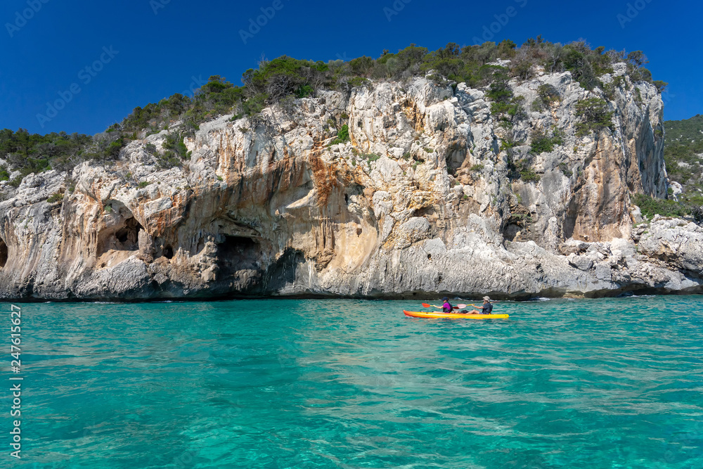 Two seater kayak sails along east shore of Sardinia
