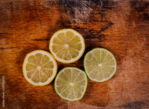 Fototapeta Naklejka Na Ścianę i Meble -  lemon slices of lime on wooden background