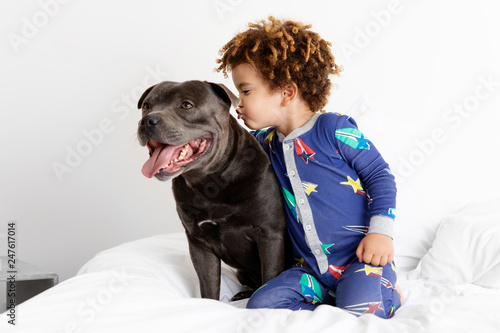 Boy about to kiss dog