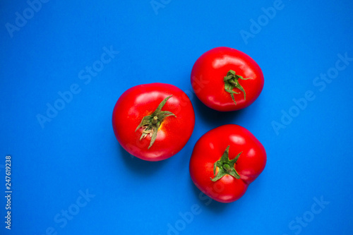 Tomatoes on a blue background © Вероника Преображенс