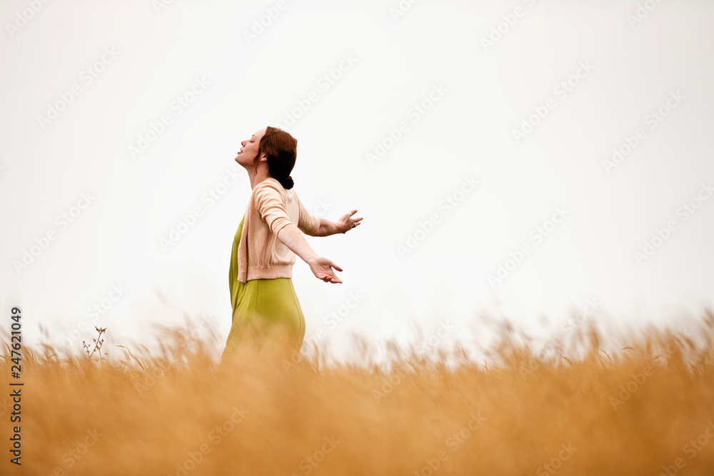 Teenage girl spinning in the wheat field. Teenage girl spinning in the wheat field.