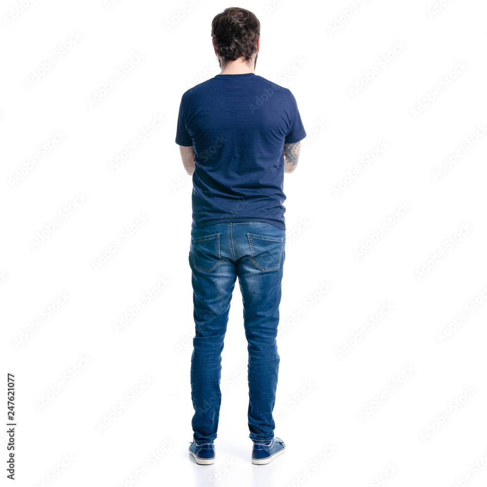 A man in jeans looks on a white background. Isolation, back view A man in jeans looks on a white background. Isolation, back view