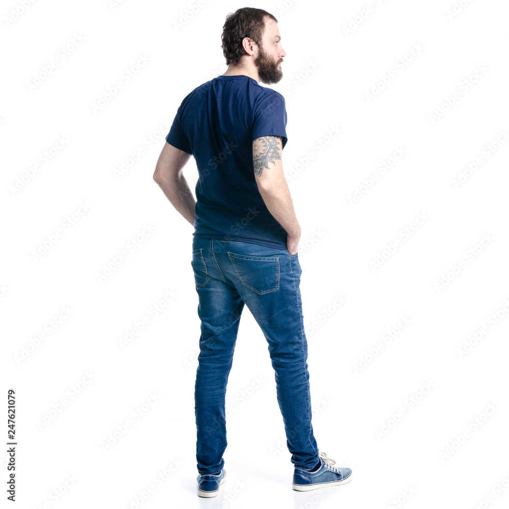 A man in jeans looks on a white background. Isolation, back view A man in jeans looks on a white background. Isolation, back view