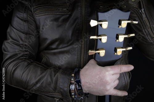 Guitarist.Closeup of electrical guitar fingerboard.Hand of rocker in leather  bracelet.Rock & roll, heavy metal,gothic,punk,horns sign and fist.Hard style.Rivets accessories © erkipauk