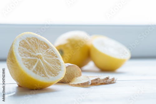 Fresh lemons and ginger on white windowsill
