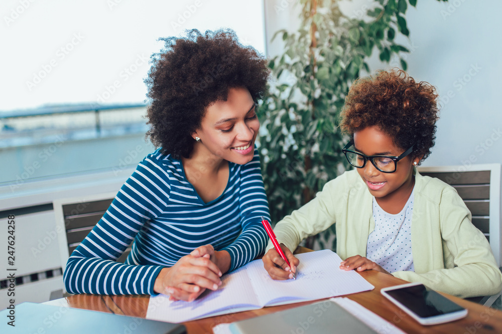 Mother and daughter doing homework learning to calculate Mother and daughter doing homework learning to calculate