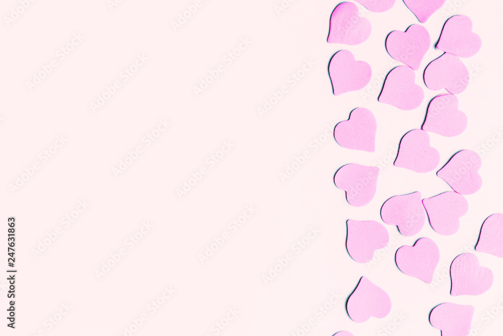 Pastel colored background with pink hearts with copy space for text