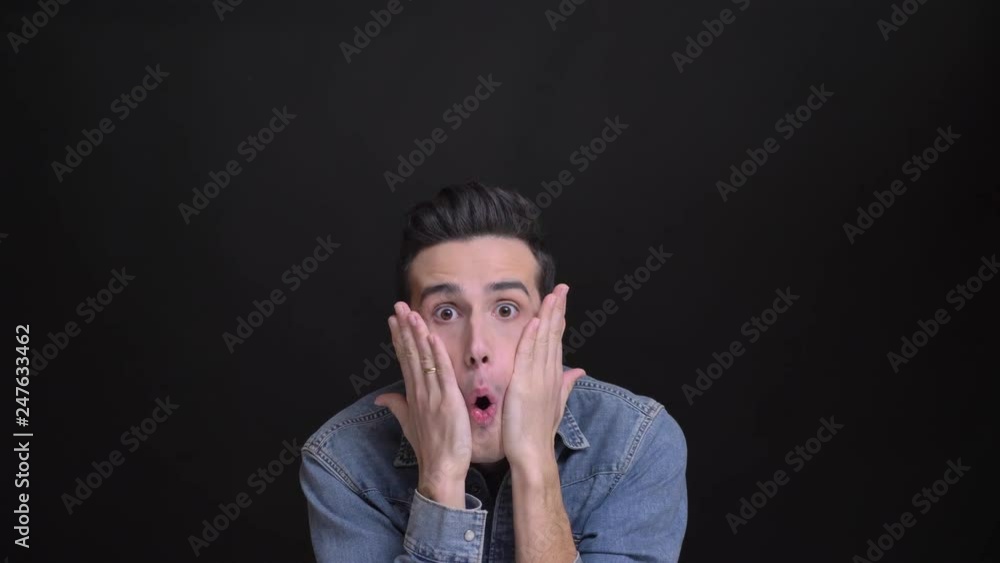 Closeup portrait of young funny caucasian man making different facial expressions and behaving silly in front of the camera Closeup portrait of young funny caucasian man making different facial expressions and behaving silly in front of the camera