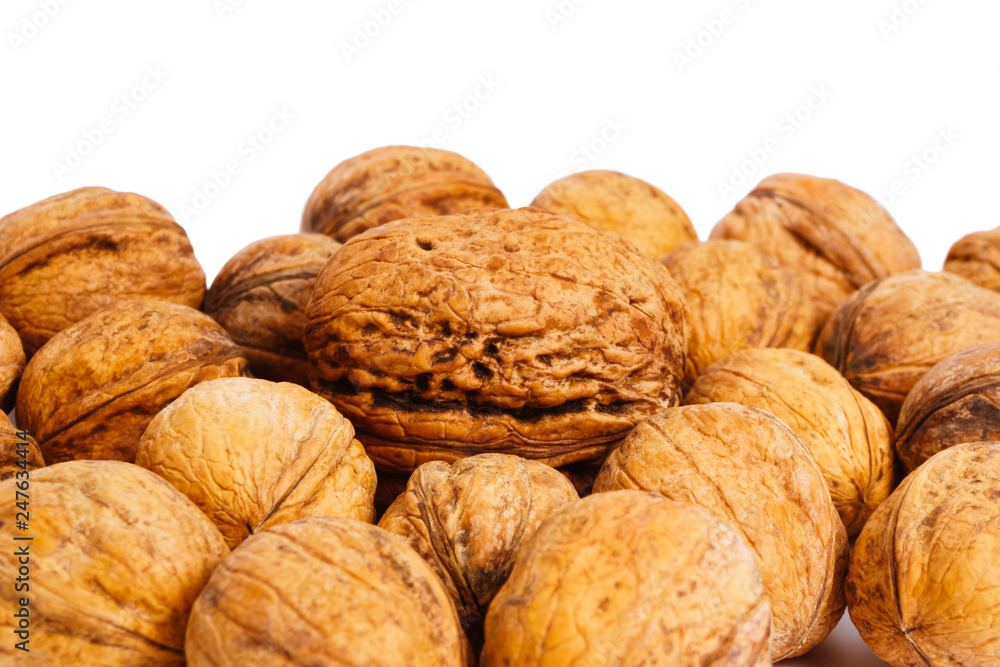heap of walnuts isolated on a white background heap of walnuts isolated on a white background