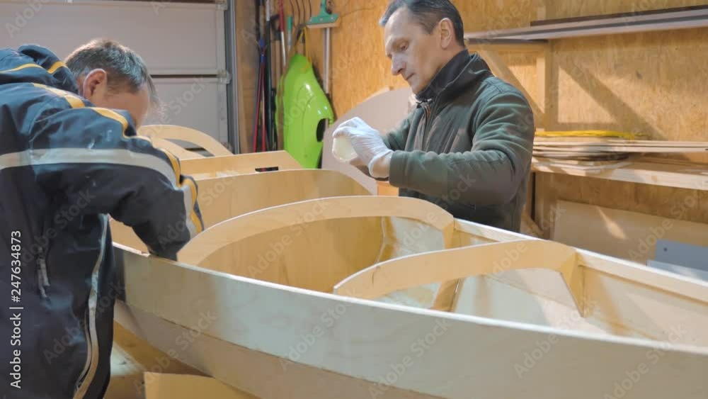 Two men independently make a boat of wood. They themselves invented the design of the vessel for their travels. Two men independently make a boat of wood. They themselves invented the design of the vessel for their travels.