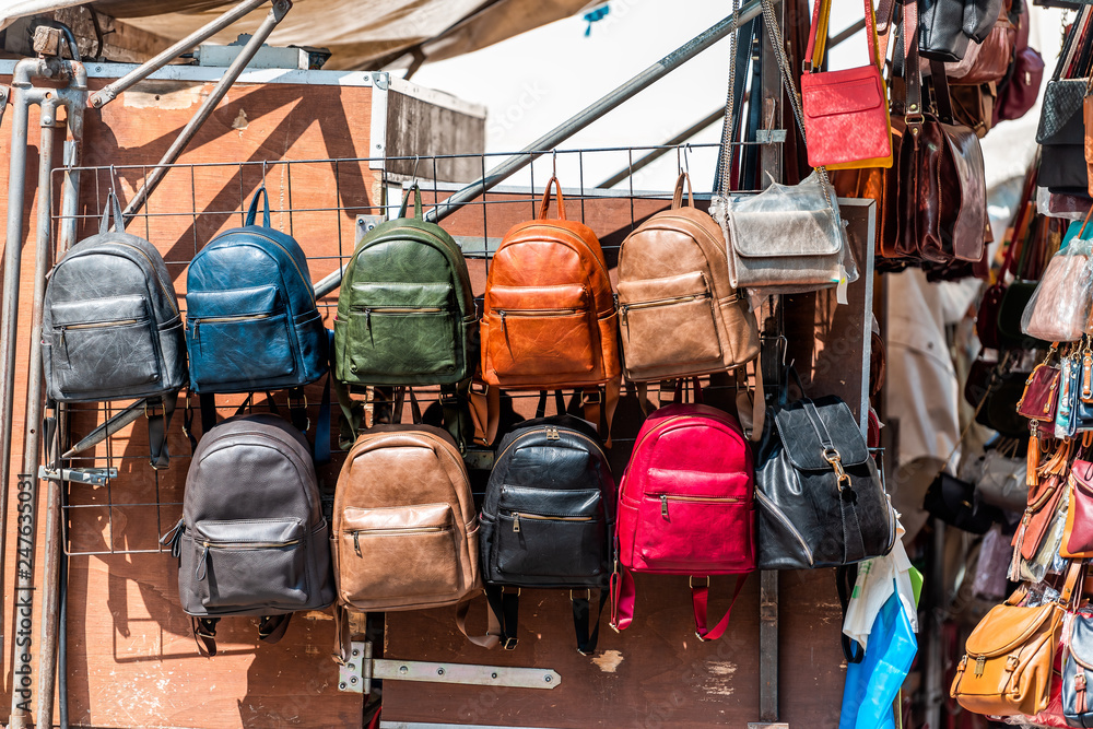 Florence, Italy Many leather purse bags colorful vibrant colors hanging on  display in shopping street market in Firenze in Tuscany Photos | Adobe Stock