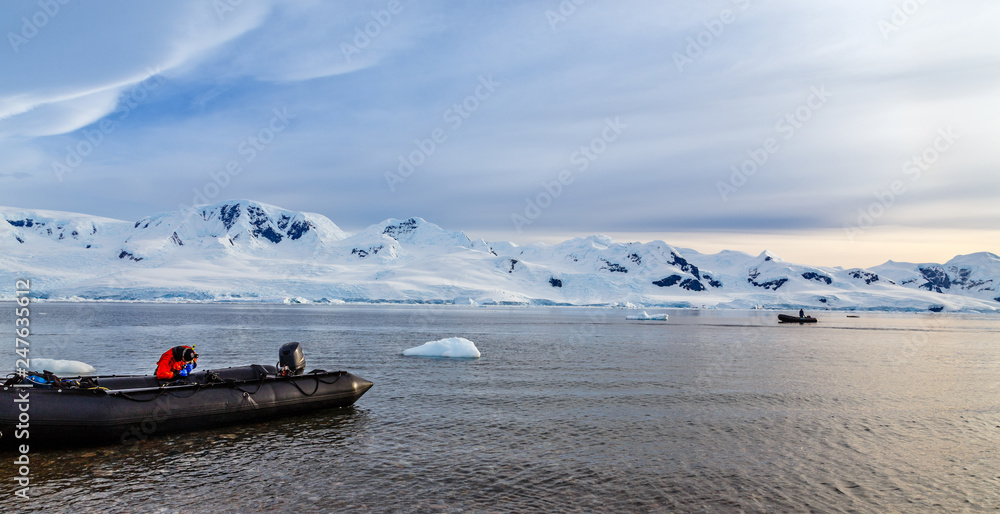 Zodiacs boats in the snow fjord of Neco bay, Antarctica Zodiacs boats in the snow fjord of Neco bay, Antarctica