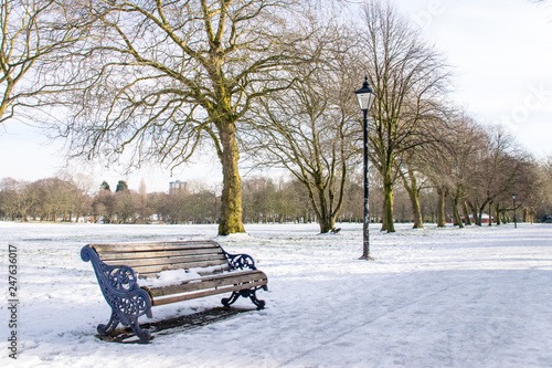 Winter landscape of Sefton Park with bench and lamp photo