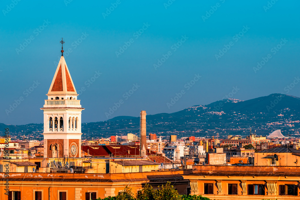 Historic Italian town of San Lorenzo in Rome, Italy cityscape skyline with high angle view of colorful architecture old buildings church tower at sunset night