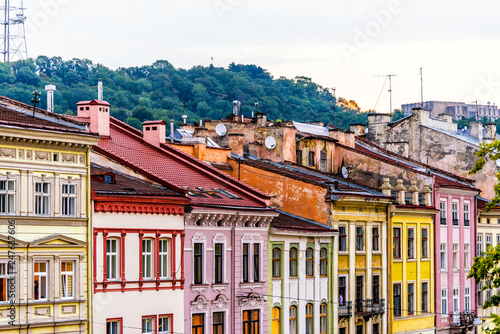 Historic Lviv, Ukraine cityscape exterior with colorful yellow red pink architecture buildings in old town market square in evening sunset multicolor houses