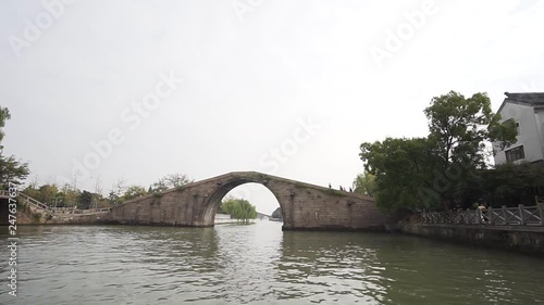 Pan from boat over Panmen Water Gate from boats point of view. Suzhou, China photo