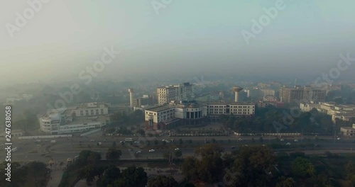 Bombay, India, Aerial flight over the horse riding ground and trraining areas, starts from the central tower buildings, foggy weather of the city, traffic is going on the highway photo