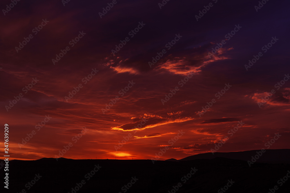 Sunset mountain peaks sky panorama. Mountain peaks sunset view. Sunset mountain peaks silhouette. Mountain sunset sky clouds