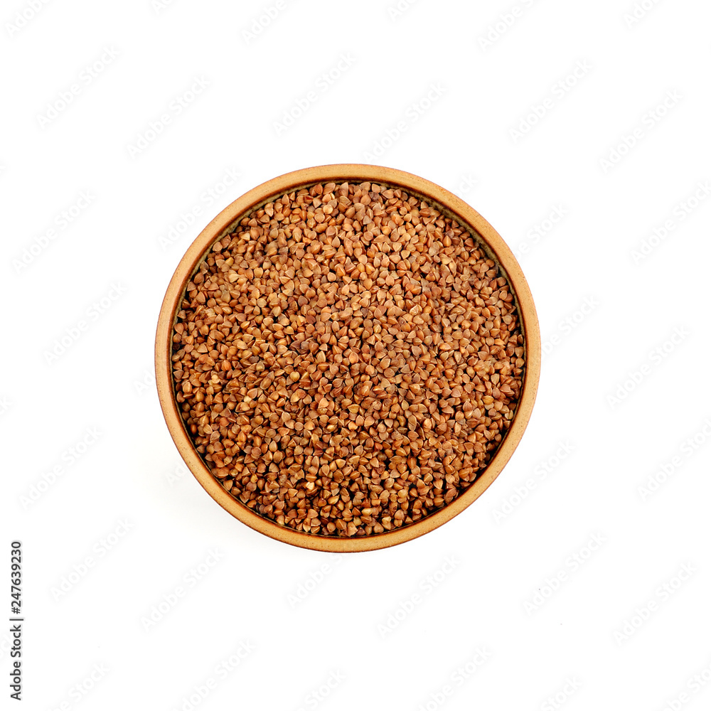 Buckwheat in a ceramic bowl isolated on white background. Buckwheat in a ceramic bowl isolated on white background.