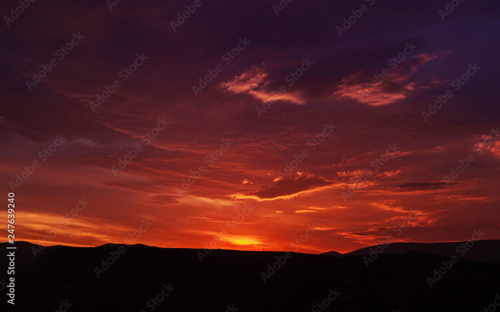 Sunset mountain peaks sky panorama. Mountain peaks sunset view. Sunset mountain peaks silhouette. Mountain sunset sky clouds