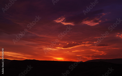 Sunset mountain peaks sky panorama. Mountain peaks sunset view. Sunset mountain peaks silhouette. Mountain sunset sky clouds