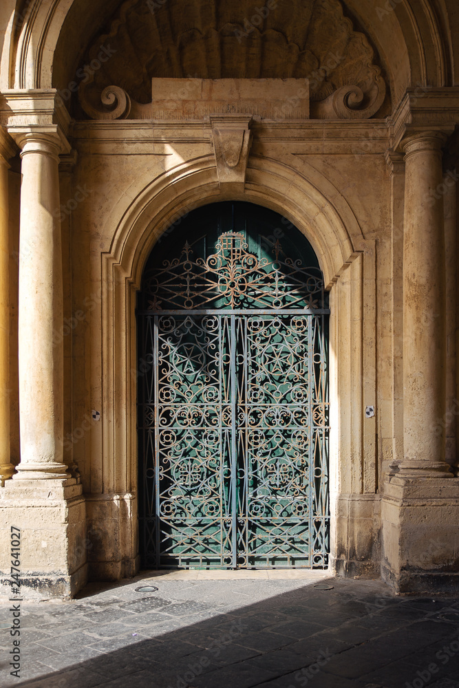 Naklejka premium Ornate metal and wood door to the grandmaster's palace courtyard in Valletta, Malta