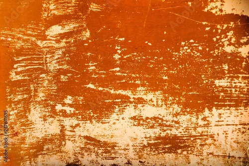 Colorful orange texture of old paint on rusty metal door