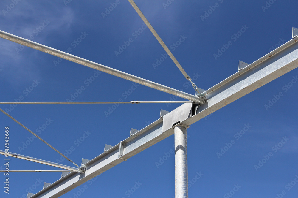 Part of the building structure of galvanized parts. Galvanized parts on a construction site in sunny weather. Installation of metal structures. Galvanized metal is not exposed to corrosion. Part of the building structure of galvanized parts. Galvanized parts on a construction site in sunny weather. Installation of metal structures. Galvanized metal is not exposed to corrosion.