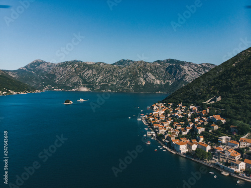 aerial view of seaside with boats and building roofs