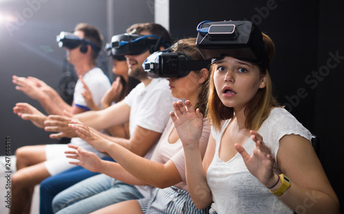 Portrait of frightened young woman after watching of exciting movie with VR glasses