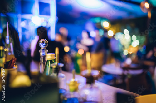 Alcoholic Cocktails and drinks and bottles at Bar counter in Night club. Night life concept image background. 