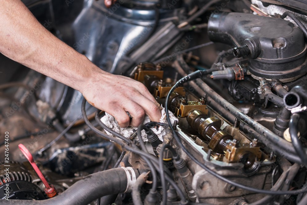 Auto mechanic working on car engine at repair service. Close up view . Auto mechanic working on car engine at repair service. Close up view .