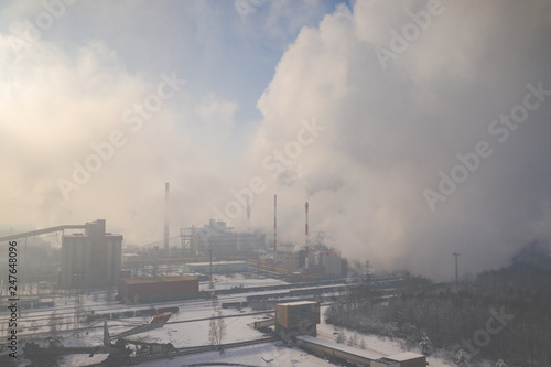 Aerial view of modern combined heat and power plant. Fuming chimney. Heavy industry from above. Power and fuel generation in Poland.