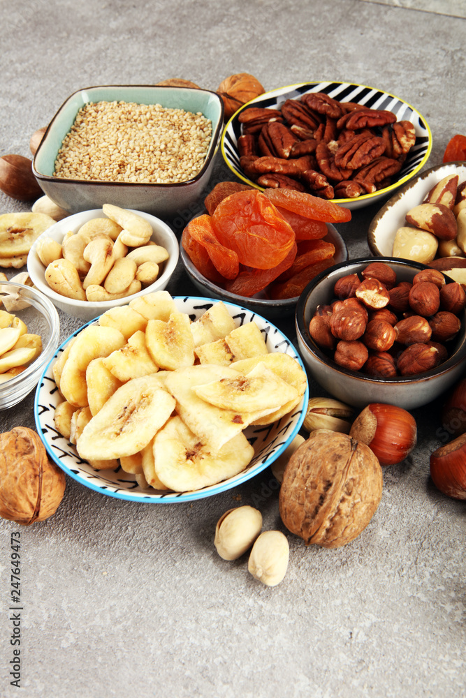 dried fruits and assorted nuts composition on rustic table