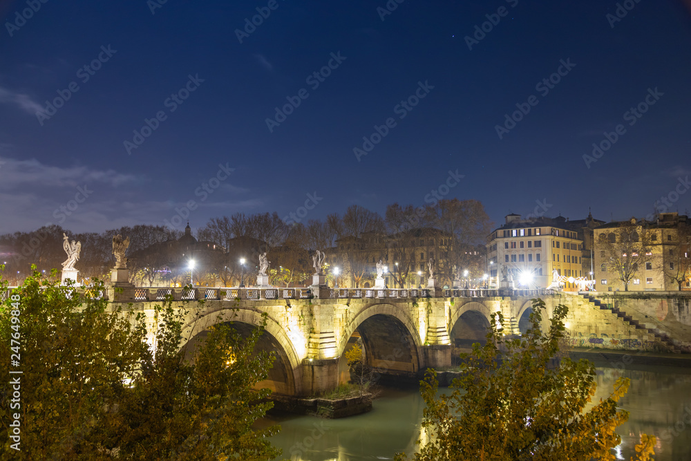 Night view of Bridge Called Ponte Sant'Angelo Crossing Tiber River Near Castle Saint Angelo and Vatican City.